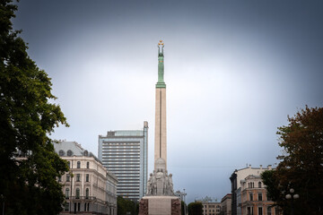 Fototapeta na wymiar Freedom monument of Riga, also called Brivibas Piemineklis, on a cloudy grey sky. Designed by Karlis Zale in 1935, it's a major landmark of Riga and latvia dedicated to latvian war of Independence.