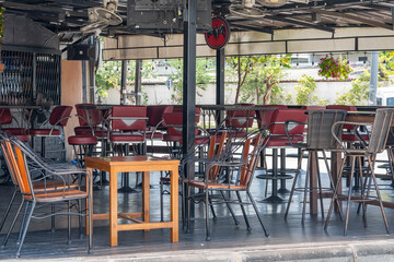 Metal chairs and bar counters in an empty bar during the day before work.