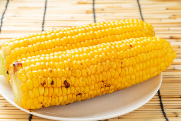とうもろこしのバター醤油焼き。背景すだれで夏イメージ。
