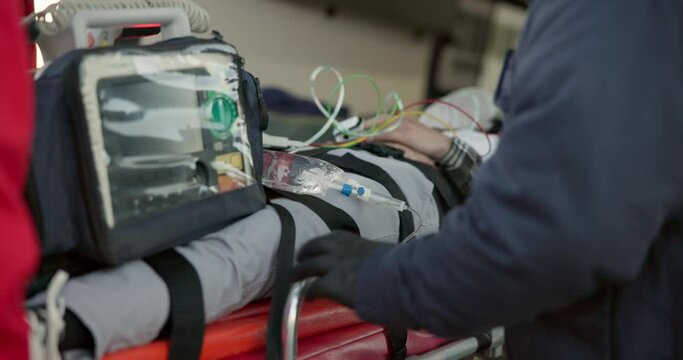 Stretcher, ambulance and patient with injury, first aid and car crash for accident on road with iv drip. Paramedic, emergency and healthcare emt with person for medical service, care and rescue