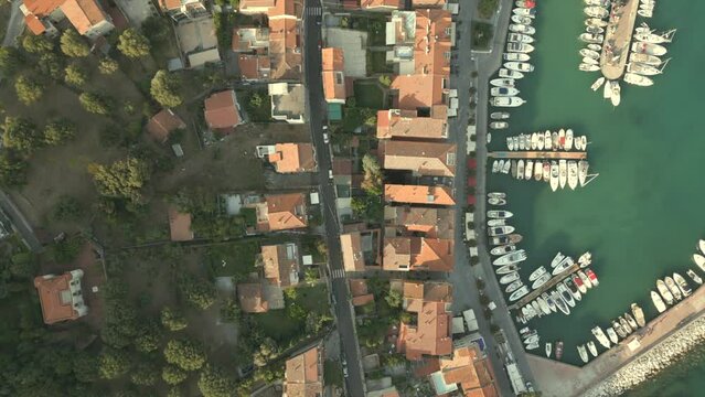 Birds view on little Italian village at the seaside (Scario, Campania), showing meditteranean houses and striving the little harbour.