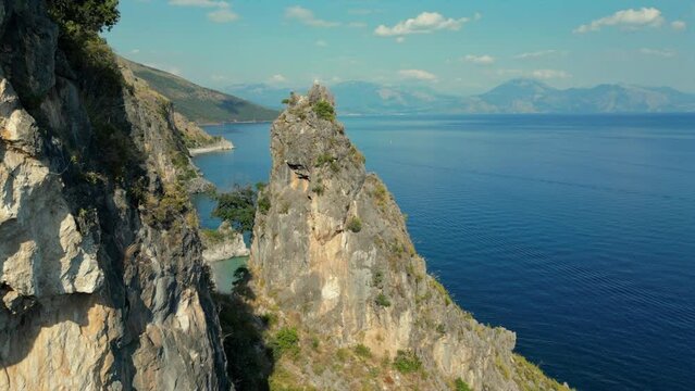 Reverse rollover flight over rough rocks at the Italian coast with a beautiful sea view.
