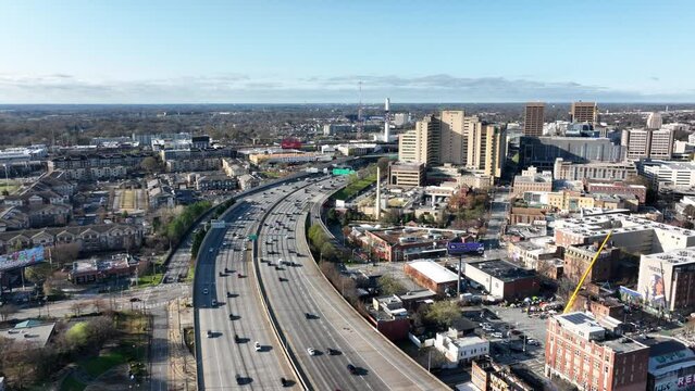 Cinematic drone shot of Downtown Atlanta busy highway, Skyline buildings, John Lewis Mural wall, and historic Butler Street YMCA, Georgia, USA