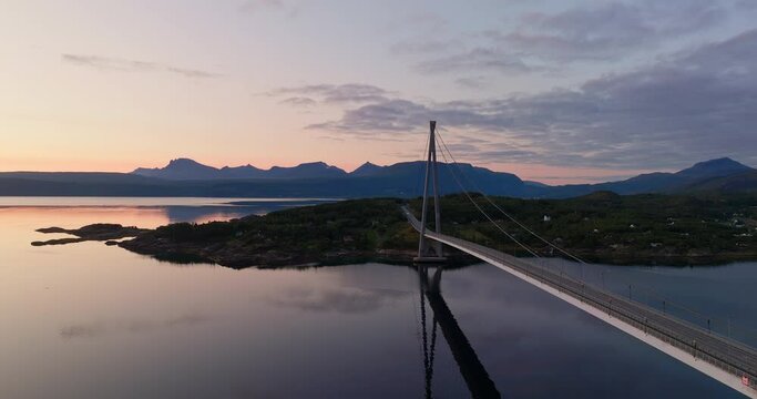 Sunset drone flight next to iconic Halogaland bridge in Narvik, Norway