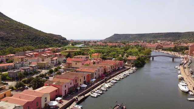 Static establishing view of Bosa river Temo, colorful Sardinian houses, Italy