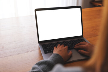 Mockup image of a woman using and working on laptop computer with blank white desktop screen