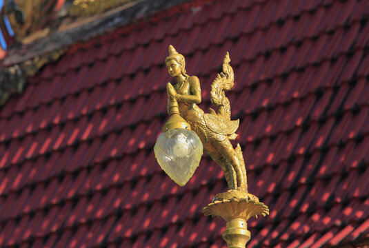 Gold lamps and lighting pole background with a blue sky,at Wat Ban Ngao (Temple), Ranong, Thailand