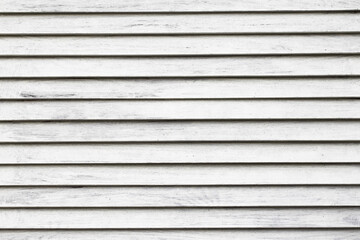 Horizontal stripes texture. White wood background. Lines pattern. White paint wooden panel. Closeup window shutter. Vintage architecture pattern.