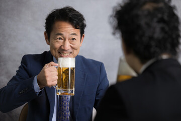 Businessmen toasting with draft beer