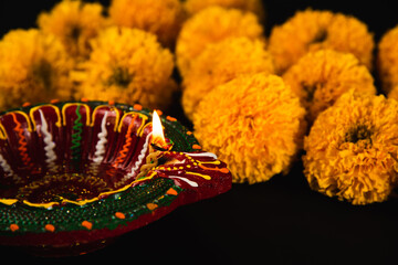Elegant Diwali decor, beautifully crafted Diwali lamp and colorful flower rangoli shining on a...