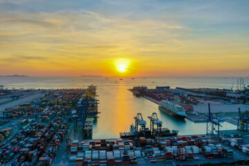 Business logistic import-export transport international and transportation of containers ships at seaport , Shipping container buildings, roads at sunset evening view of Shipping containers. - obrazy, fototapety, plakaty