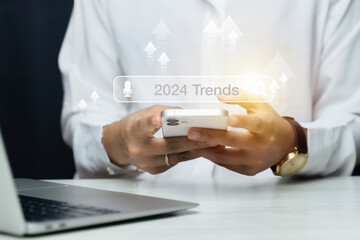 Woman touching to search engine bar with 2024 trends wording for marketing monitor and business...