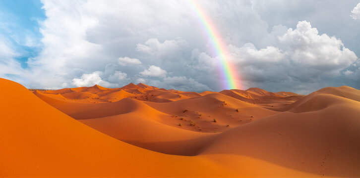 Sand dunes in the Sahara Desert with rain and rainbow - Morocco - Orange dunes in the desert of Morocco - Sahara desert, Morocco