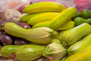 green bananas lie next to green zucchini
