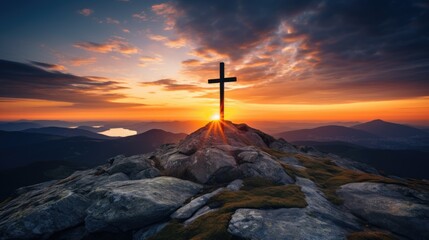 Christian cross in the peak of a mountain at sunset.