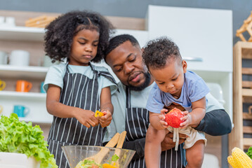 african afro black daughter kids with daddy father happy family funny for teach cooking. Black...