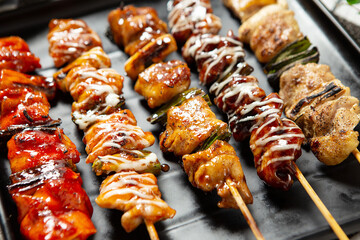 Chicken skewers in various flavors on a plate