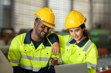 Factory apprenticeship. Man mentor teaching Female employees trainee operating machine looking monitors and check Production process machinery. foreman explaining woman engineer control machine .