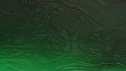 Green colorful deep water with ink and oil drops matte beautiful transition, abstract background wallpaper.