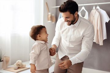 Happy dad helping his little son put on clothes