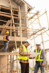 Co-workers discussing architecture projects at construction site at table Architects work with Engineer inspects site for construction project draft, architectural plan