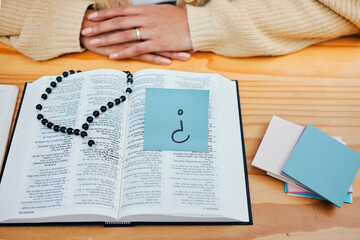 Woman, bible study and question on sticky note, rosary and god for worship, religion and spiritual....