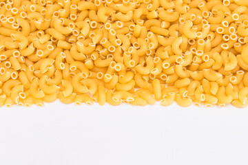 Uncooked Chifferi Rigati Pasta Scattered on White Table. Fat and Unhealthy Food. Classic Dry Macaroni. Italian Culture and Cuisine. Raw Pasta