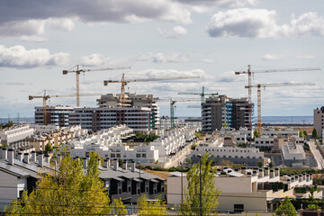 Construction of new modern buildings for housing in the expansion areas of Madrid, Spain. - obrazy, fototapety, plakaty