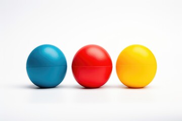 three stress balls of different colors on a white backdrop