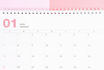 January 2024 calendar close-up on pink background, planning concept.
