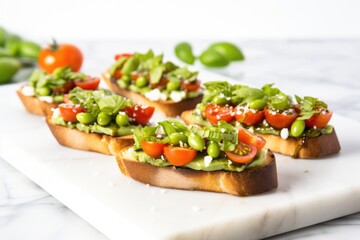 a row of edamame bruschetta set on a marble surface