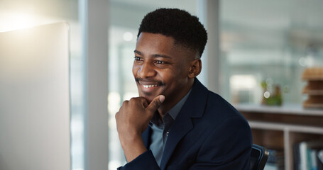Businessman, thinking and reading on computer with a smile in office for email, feedback or communication. Working, online or black man with research, inspiration or ideas from Nigeria report or news