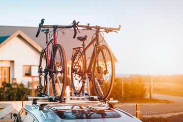 Transportation of bicycles on the roof of the car. Concept of a summer trip on a car trip with a...