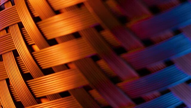 Close-up of woven steel mesh rotating smoothly. Teal and orange cinematic look. Macro shooting