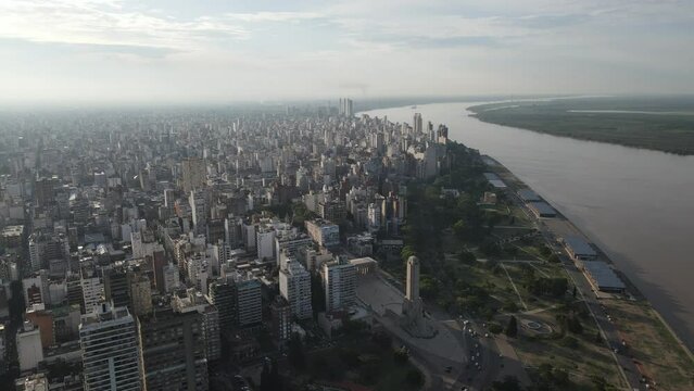 Drone at sunset over the city of Rosario Argentina where you can see the National Flag Monument, the Parana River and much of the city the image the image goes backwards and you can see the traffic