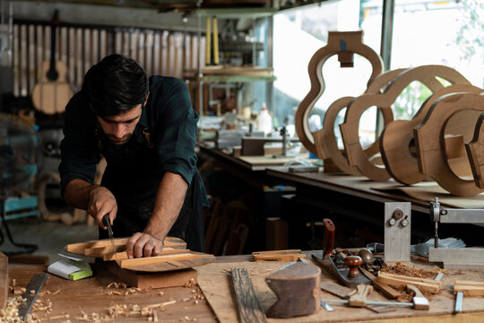 Guitar Luthier Uses Hand Saw to Cut Guitar Bracing - Powered by Adobe