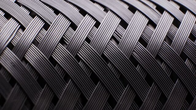 A close-up of the metal fabric rotates smoothly. Flexible braided pipe made of heat-resistant stainless steel. Materials Science and Engineering. Vibration damper