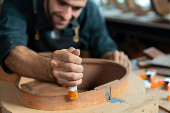 Luthier Inspects Kerfin Lining on Guitar Body
