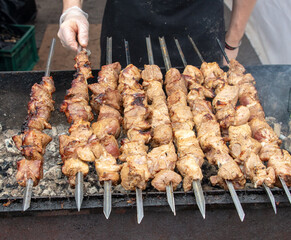 The meat is fried on the grill over the coals of the grill