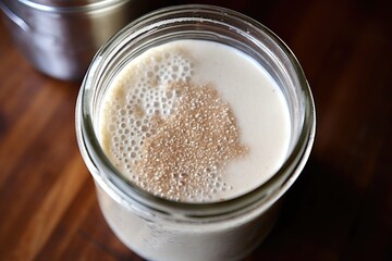 sourdough starter bubbling in a glass jar