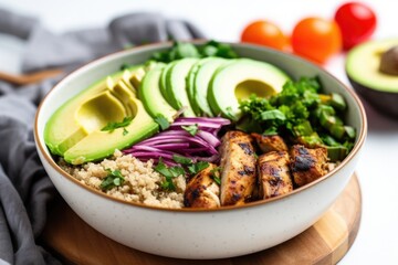 quinoa bowl with grilled chicken pieces and avocado slices