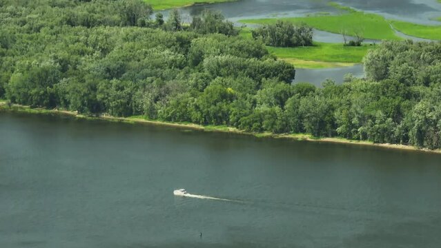 Speedboat Cruising In The Mississippi River Along The Great River Bluffs State Park In Minnesota, USA. - aerial