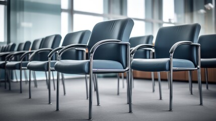 A row of empty office chairs in a contemporary meeting room.