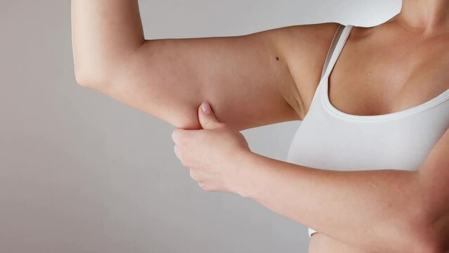 Close-up Of A Woman Holding Arm With Excess Fat