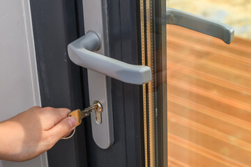 Wkładać klucz do zamka w drzwiach balkonowych w domu