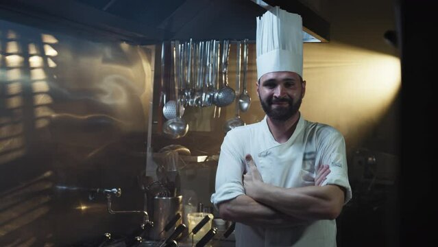 Chef wears chef's hat and smiles
