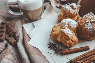 Cozy morning composition, cup of coffee, custard cakes and candle