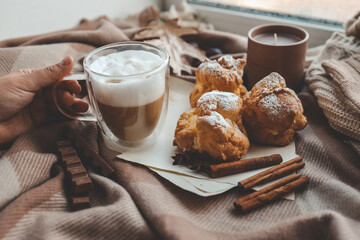 Cup of coffee in hands, cozy autumn