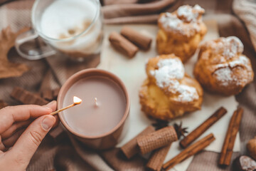 Lighting a candle, cozy autumn photo