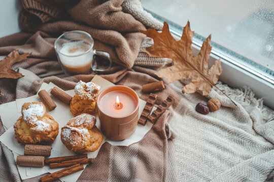 Burning candle with the smell of chocolate and cinnamon in a cozy home interior